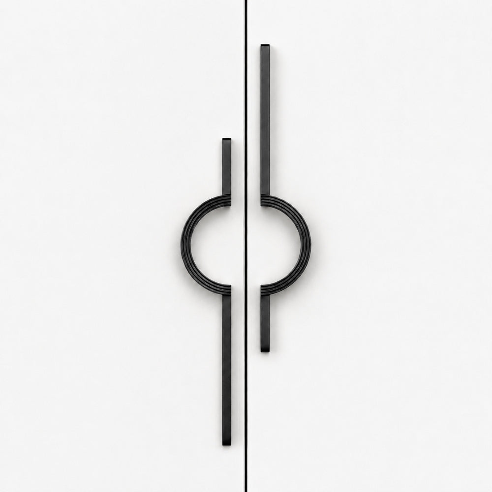 A pair of modern black metal cabinet handles with a minimalist circular and linear design, shown on a clean white background.