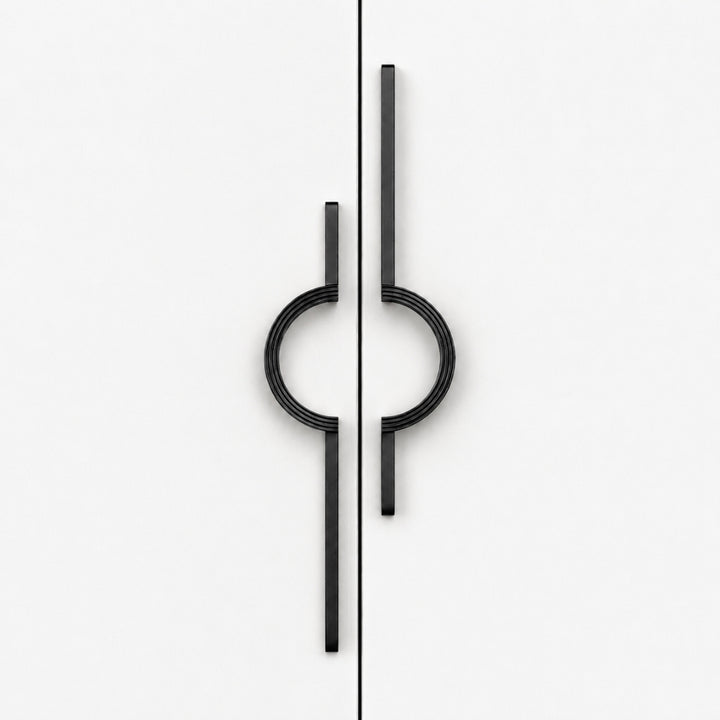 A pair of modern black metal cabinet handles with a minimalist circular and linear design, shown on a clean white background.