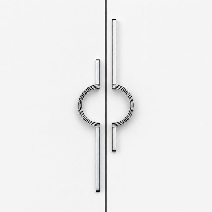 A pair of modern, minimalist cabinet pulls with a polished silver finish, featuring a circular ring design integrated with two vertical bars, shown on a clean white door split by a vertical seam.