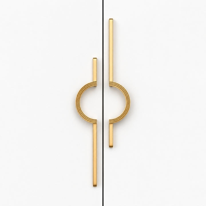 A pair of modern gold cabinet handles with a minimalist circular and linear design, shown on a clean white background split by a vertical seam.