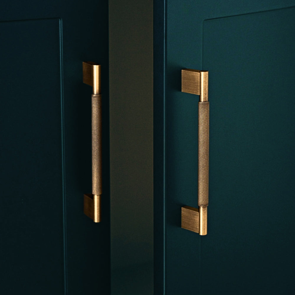 Antique brass 5-inch pull installed on kitchen cabinet